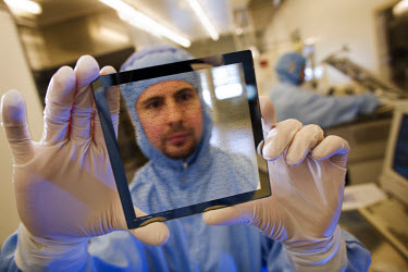 Scientist Zachavy J. Davis with a lithography mask in the clean room for producing nano and micro components in the MIC department at the Technical University of Denmark (DTU). The centre's work focus...
