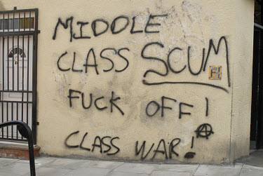 Anti middle class graffiti on a wall at Broadway Market in the Hackney area of East London. The street has undergone rapid gentrification.