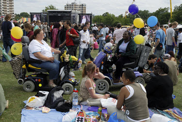 Two women driving mobility vehicles attend the Rise anti-racism music festival in Finsbury Park. The event is organised by the Mayor of London's office.