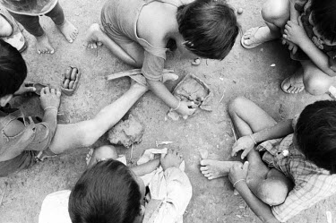 Kayan (Karenni) children, refugees from Burma, playing with mud toys in the Nu Pu Ah refugee camp.