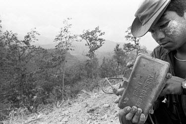A Karenni Army soldier priming a claymore mine shortly before the second battle for Ember Hill. It was estimated later that over 300 Burma Army soldiers lost their lives during the two battles that di...