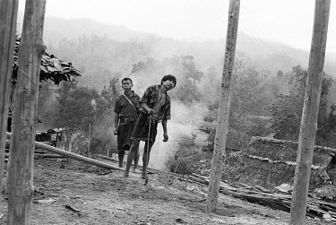 Two Karen men in the process of building a new wood and bamboo house in an internally displaced persons (IDP) camp in Kaw Thoo Lei - the Karen State of Burma. The Burma Army have burnt down other IDP...