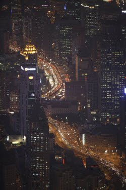 A view of the bright lights and traffic in the Pudong Financial District from the top of the Shanghai World Financial Centre.