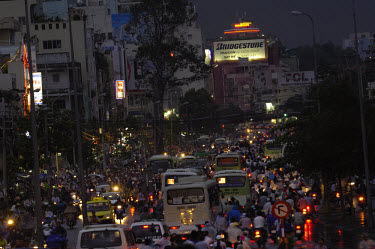 Rush hour traffic jams at dusk dominated by two-wheeled traffic.