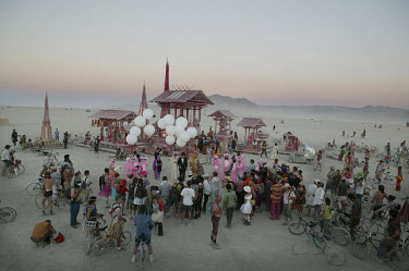 People at the Burning Man Festival gather around the Dream Temple constructed by Mark Grieve, where many come at sunset to celebrate weddings. Each year tens of thousands of people amass in the Nevada...