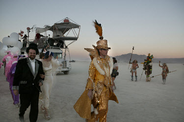 People in elaborate costumes make their way towards the Dream Temple for a wedding ceremony during the Burning Man Festival. Each year tens of thousands of people amass in the Nevada desert to take pa...