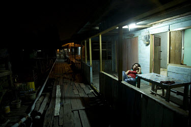 An Indonesian sex worker, waits for customers in a brothel on Babi island. As a result of the increased patrols, piracy has gone down and the sex workers have lost some of their most important custome...