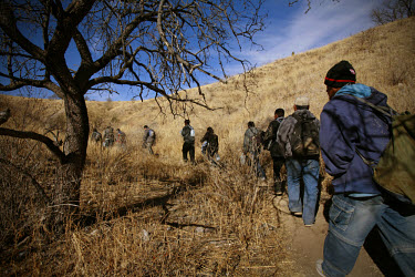 A group of migrants walk through the Arizona desert shortly after crossing the border from Mexico.