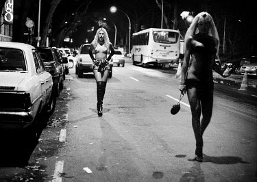 Two transvestite sex workers waiting for customers in the Tavares Bastos favela.