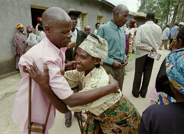 Prisoner at a Gacaca trial greets his family. Gacaca is a traditional form of jurisdiction, now used to try participants of the 1994 genocide. It is a nationwide justice project based on a Rwandan tra...