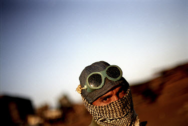 A worker from the Gaddani ship-breaking yard covers his face with his scarf to protect him from dust.