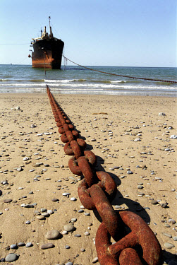 A ship waiting to be dismantled is tethered with heavy chains. In the days when Gaddani ship-breaking yard was still in full operation it wasn't uncommon to find hundreds of ships here, all waiting to...