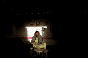 A worker resting in his quarters at the Gaddani ship-breaking yard.