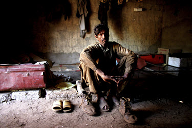 A worker takes a short break from his work at the ship-breaking yard in Gaddani.