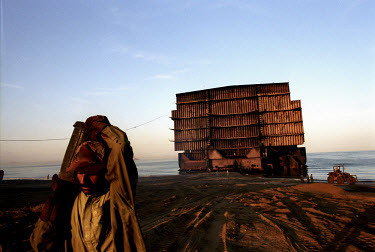 Workers dismantle a huge ship and carry it off piece by piece at the ship-breaking yard in Gaddani.