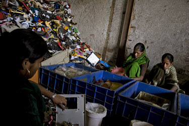 Women work in a plastic recycling unit in the Dharavi slum.
