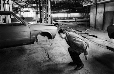 Quality inspector in the Zastava car plant, makers of the Yugo car. The plant suffered bomb demage during the NATO campaign and is operating at 25 percent capacity.