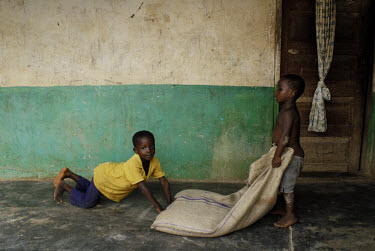 Children play outside the house of a Kuapa Kokoo cocoa co-operative worker. Kuapa Kokoo is a cocoa farmers' co-operative with 45,000 members spread across the forests of Kumasi. The farmers are all eq...