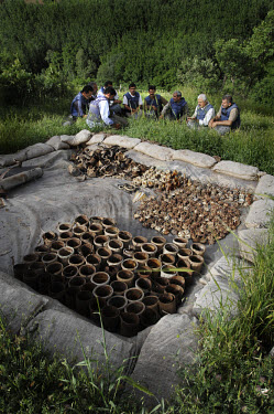 De-miners take a rest close to the area where defused landmines are kept before they are destroyed.