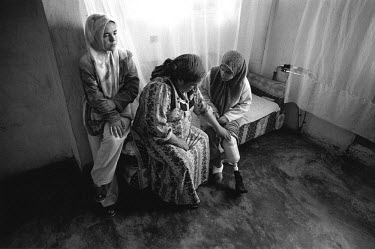 17 year old Rasha with her mother and sister. She was lying on the sofa when her little sister brought in a bag of thyme her father had just harvested from their field. Inside the bag was an unexplode...