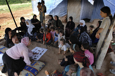 MAG (Mines Advisory Group) community Liaison staff talk to a group of Iraqi Kurds in the Sheladaz camp for displaced persons. The camp is situated close to a minefield and the staff at MAG are at the...