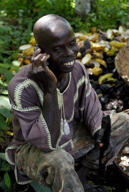 Kuapa Kokoo farmer talks on a mobile phone. Kuapa Kokoo is a cocoa farmers' co-operative with 45,000 members spread across the forests of Kumasi. The farmers are all equal owners of Kuapa, which in tu...