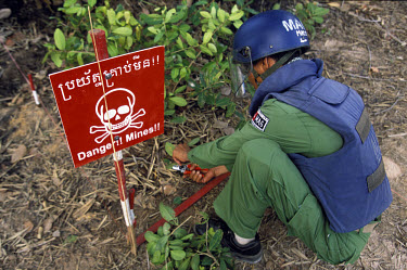 Landmine victim who is an amputee now trained to defuse mines with MAG (Mines Advisory Group).