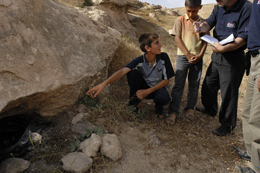 Children take a MAG (Mines Advisory Group) Community Liaison team to a site where they have seen what they think to be dangerous items. The items turned out to be BLU 97 cluster bombs. Ator, the Commu...