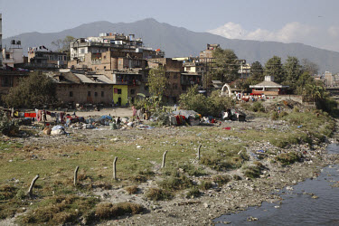 Rural migrants, living in tents by the side of the river, make a living from recycling rubbish.