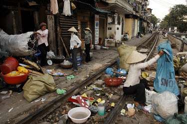 A well organised recycling operation provides employment for locals in a slum area of Hanoi situated beside the railway track.