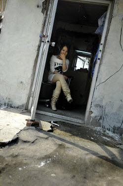 A migrant woman, working as a sex worker, waiting for afternoon business in a poor district of the city. Prostitution, although illegal, is a massive industry in China, and rises in the rate of HIV in...
