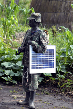 A Lord's Resistance Army (LRA) soldier carrying a portable solar panel at peace talks near the Congolese border attended by the LRA leader Joseph Kony. For the last two decades Joseph Kony and the Lor...