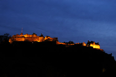 Edinburgh Castle, illuminated at night, with buildings dating from the 12th to the 20th century.