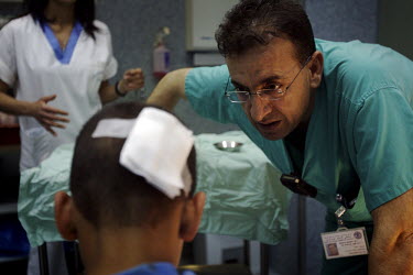 A doctor speaks with a patient in the Emergency Room. Nazareth Hospital is staffed by Muslim, Christian and Jewish doctors all working together despite religious and political differences to save the...