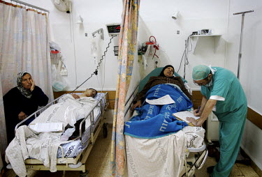 A Christian doctor treats patients in the recovery room. Nazareth Hospital is staffed by Muslim, Christian and Jewish doctors all working together despite religious and political differences to save t...