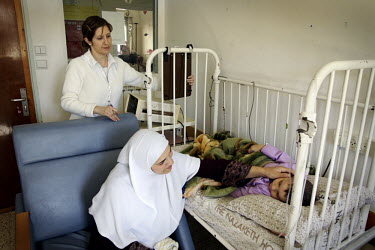 A Muslim child is treated by a Christian Nurse in the Children's Ward. Nazareth Hospital is staffed by Muslim, Christian and Jewish doctors all working together despite religious and political differe...