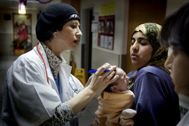 Dr Ella Sela (Jewish, 45, Paediatric Doctor) does her rounds checking all newly delivered babies. Nazareth Hospital is staffed by Muslim, Christian and Jewish doctors all working together despite reli...