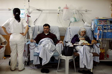 A Christian man sits for four hours three times a week next to a Muslim woman while they receive dialysis. Nazareth Hospital is staffed by Muslim, Christian and Jewish doctors all working together des...