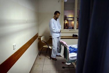 A muslim patient conducting his evening prayers. Nazareth Hospital is staffed by Muslim, Christian and Jewish doctors all working together despite religious and political differences to save the lives...