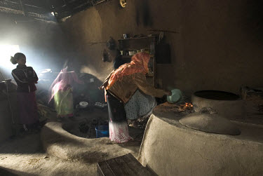 A woman cooks in her newly designed kitchen. It was built to be more economical, using less wood, staying hot for longer and producing less smoke.