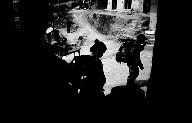 Maoist guerillas enter a village in Ropla District, one of the Maoist strongholds during the 1996 - 2006 civil war.