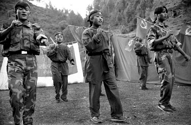 Young Maoists dance in a village in Ropla District, one of the Maoist strongholds during the 1996 - 2006 civil war.