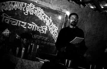 Lekhnath Neupane, president of the Maoist-affiliated student body All Nepal National Free Students Union (ANNFSU-Revolutionary), speaks at a political meeting in a village in Rolpa District, one of th...