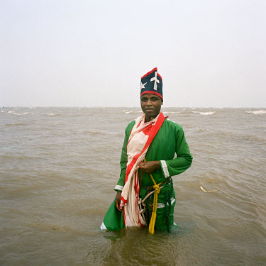 A Curandeiro from the "Ziones" group stands in the Indian Ocean after his daily spiritual session. Mozambican Curandeiros are traditional healers, who cure all sorts of ailments from psychological ill...