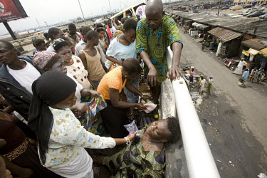 A woman is doused with water after she was involved in a traffic accident on Third Mainland Bridge.