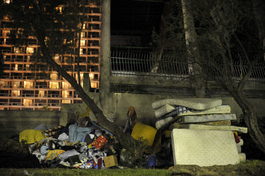 Mattresses and blankets are piled up in a park next to Hilton hotel in Tel Aviv, after a tent compound designated for African asylum seekers was dismantled.