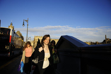 Young women in morning rushhour on North Bridge in Edinburgh city centre.