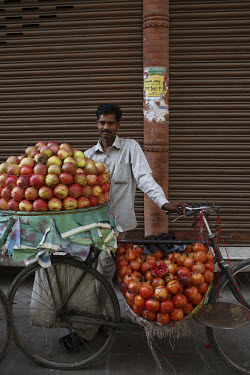 A street vendor selling apples and pomegranates on the streets of Kathmandu.