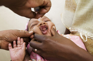 Sister Aster gives three month old Ammanel Hailu his polio vaccination at the Tulla health clinic.