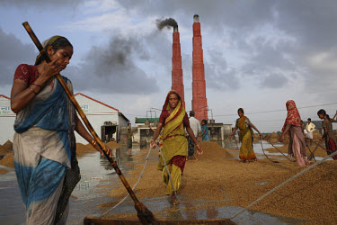 Women work at a rice mill in Asuganj. This year's harvest was ten percent larger than the previous year, yet with the current increase in worldwide rice prices, the price in Bangladesh is likely to re...